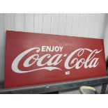 A metal painted Coca Cola sign