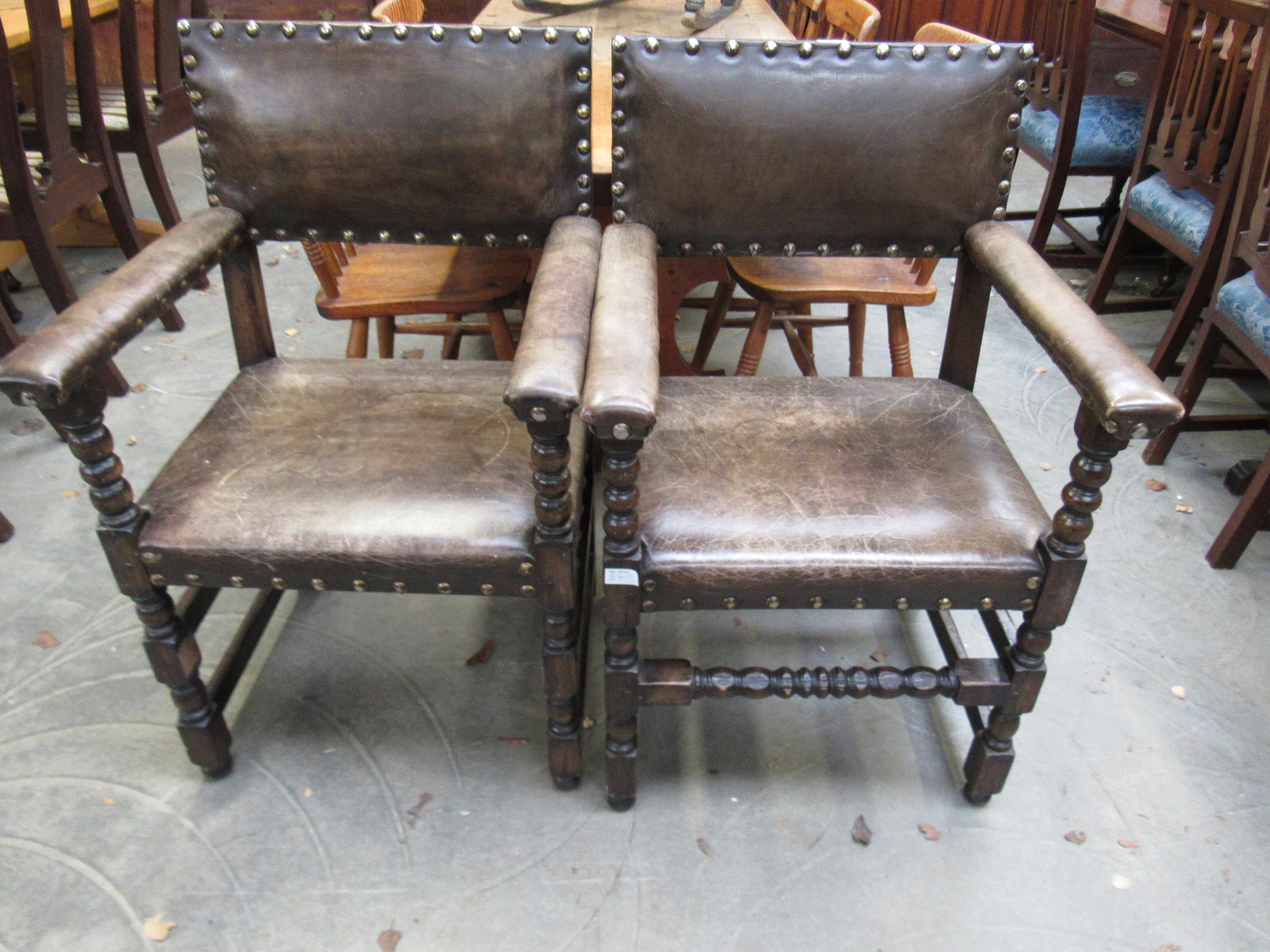 Two leather Jacobean style carver chairs,