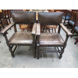 Two leather Jacobean style carver chairs,