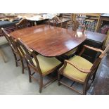 A Regency style mahogany dining table on single column and splayed legs and six (4+2) wheat ear