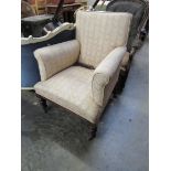 A Victorian walnut armchair with wavy design striped upholstery, turned legs,