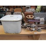 A bag of bygone golf clubs and an enamel bread bin