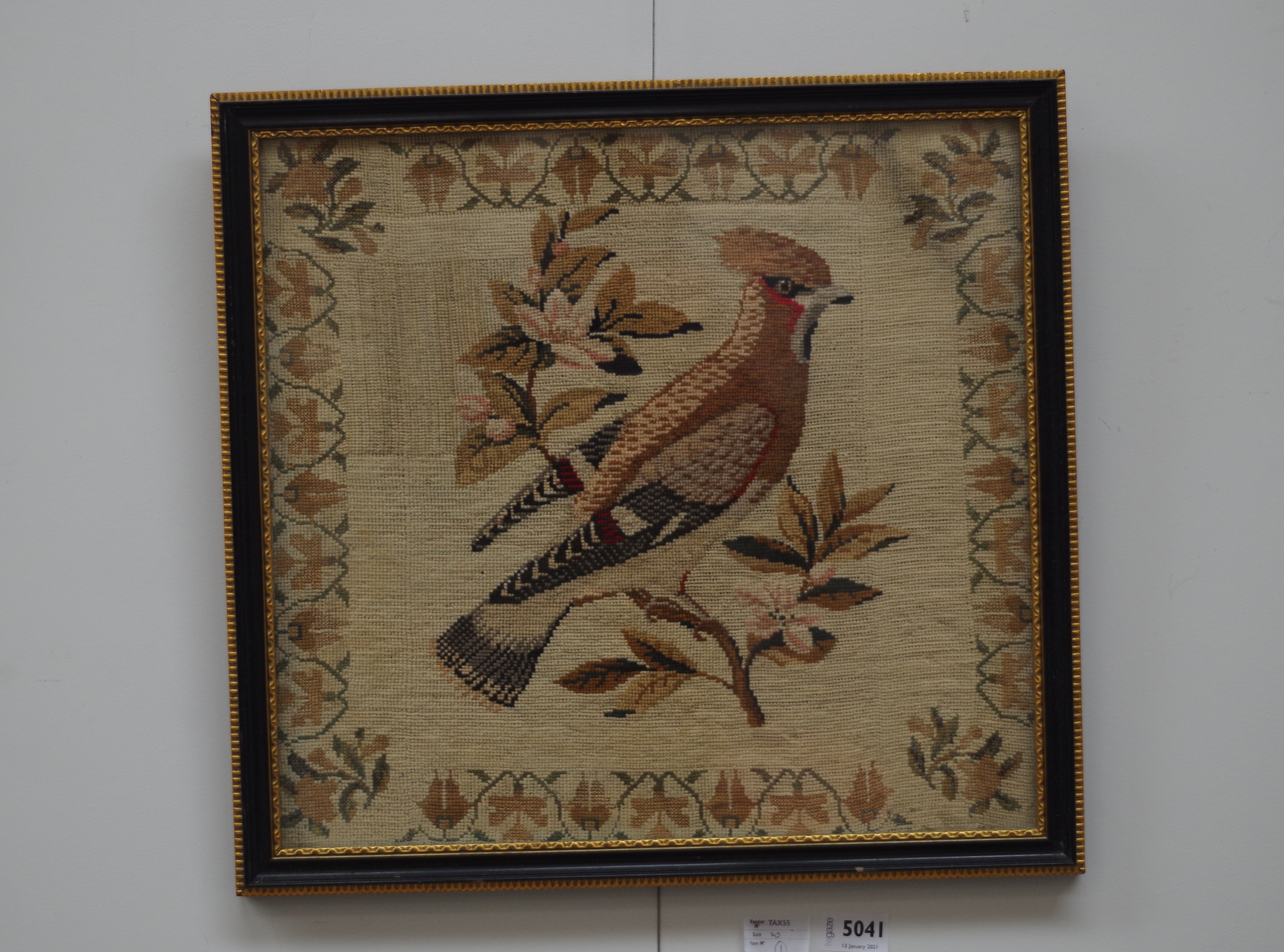 A Victorian tapestry depicting a bird in naturalistic setting,