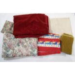 A box containing a quantity of upholstery and curtain fabric including velvet,