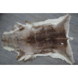 A reindeer skin rug,