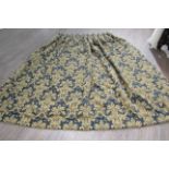 A blue and stone repeated flock pattern door curtain, lined,