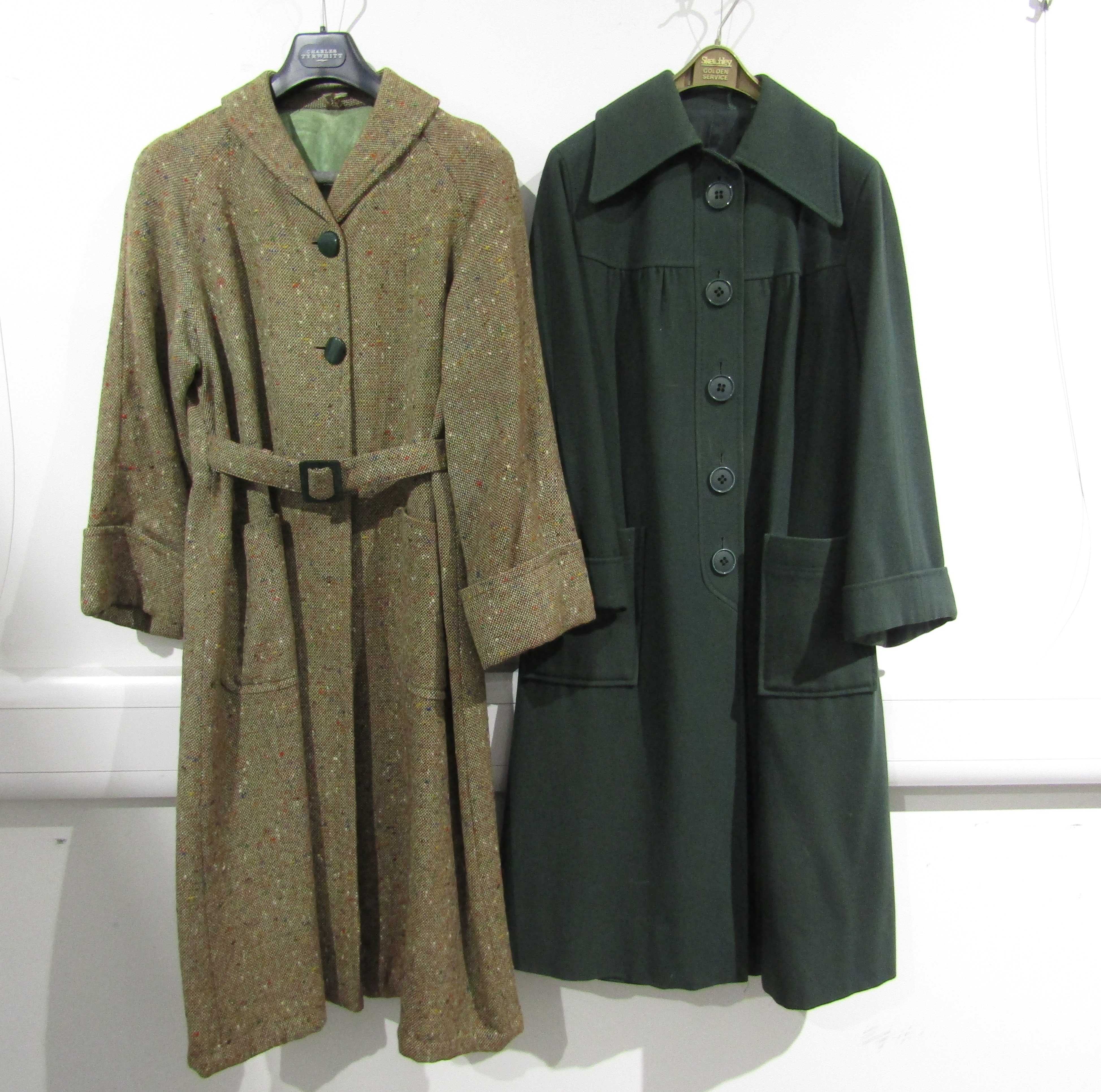 A dark green wool coat with a large collar, turn back cuffs, seamed yolk,