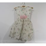 A 1960's Harrods label child's party dress with an all over floral pattern,