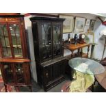 A heavily carved oak bookcase with astragal glazed doors,