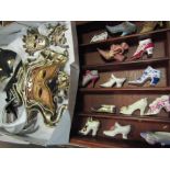 A quantity of masquerade masks and miniature ceramic shoes