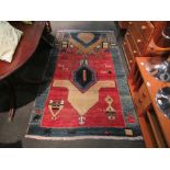 A modern Aztec design rug in blue, red and beige, 4' x 7' approx.