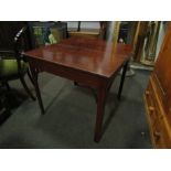 A mahogany tea table with arched supports,