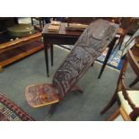 An African hardwood tree trunk chair carved with various African animals