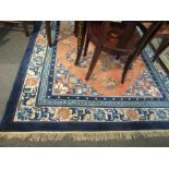 A Chinese wool rug, blue ground with multiple borders and central field,