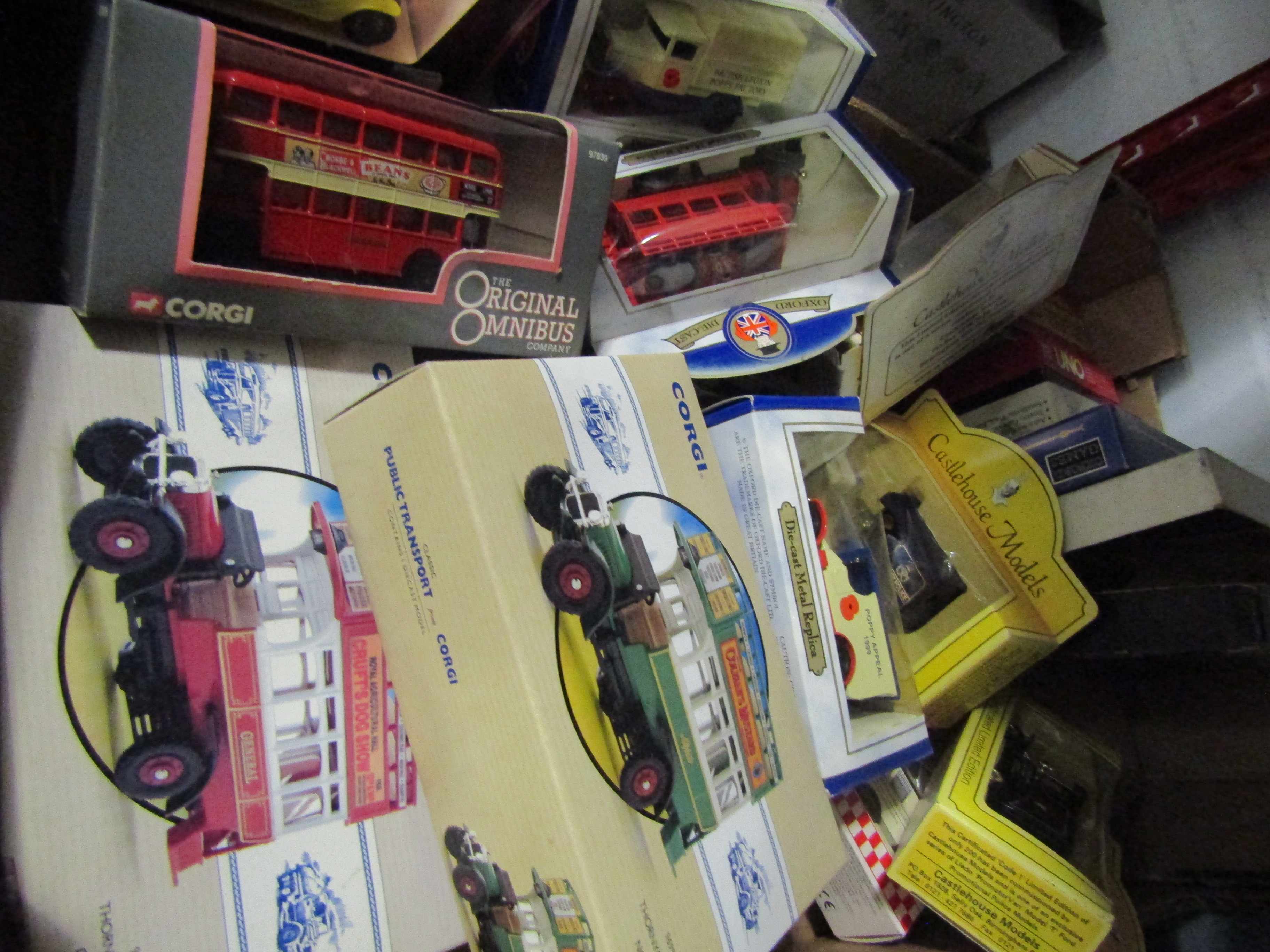 A box of mixed diecast toys and games