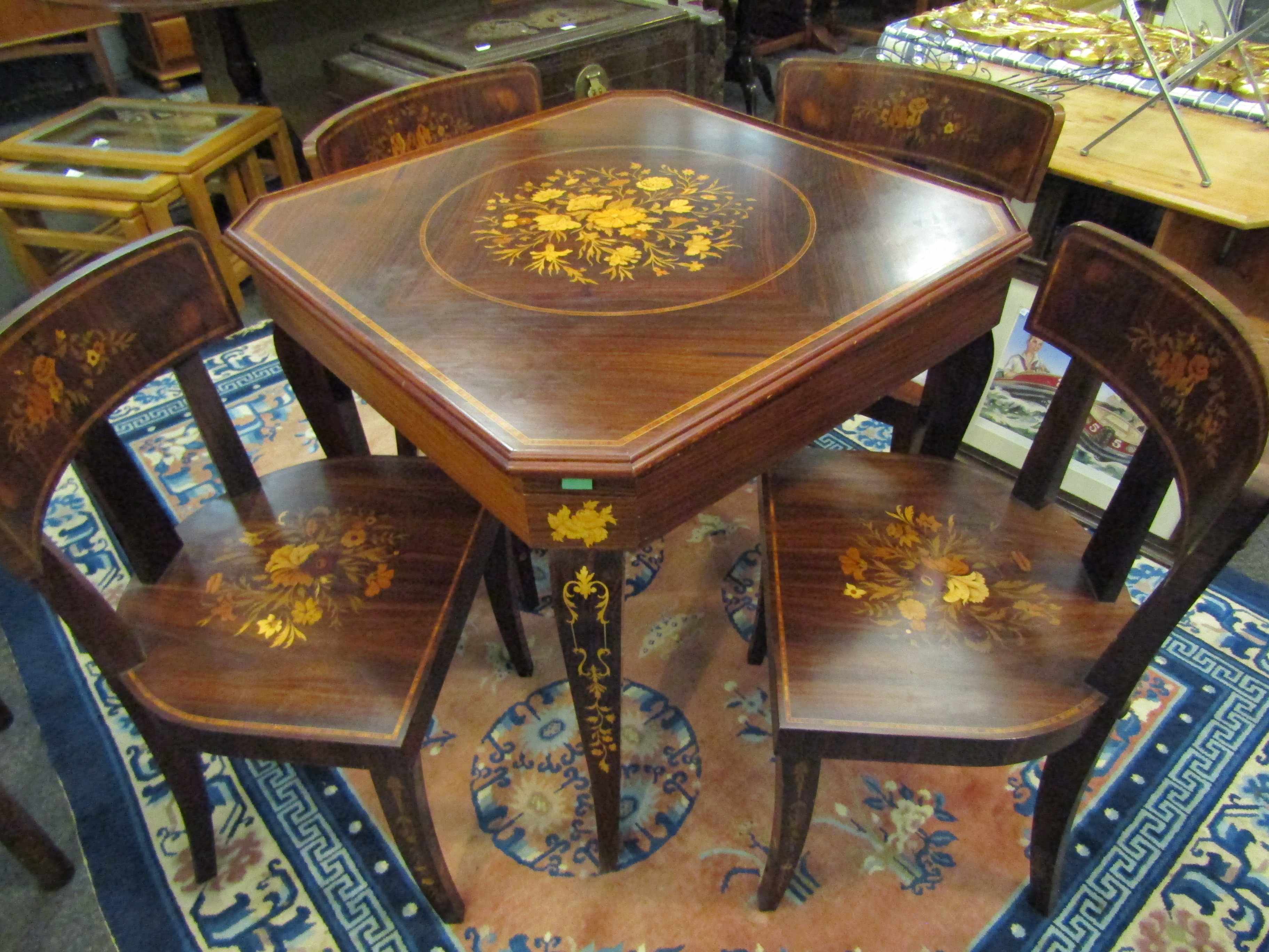An Italian Indian rosewood games table with marquetry floral inlay.