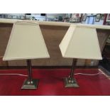 A pair of modern brushed metal table lamps