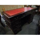 A Regency revival mahogany twin pedestal desk with tooled red leather top