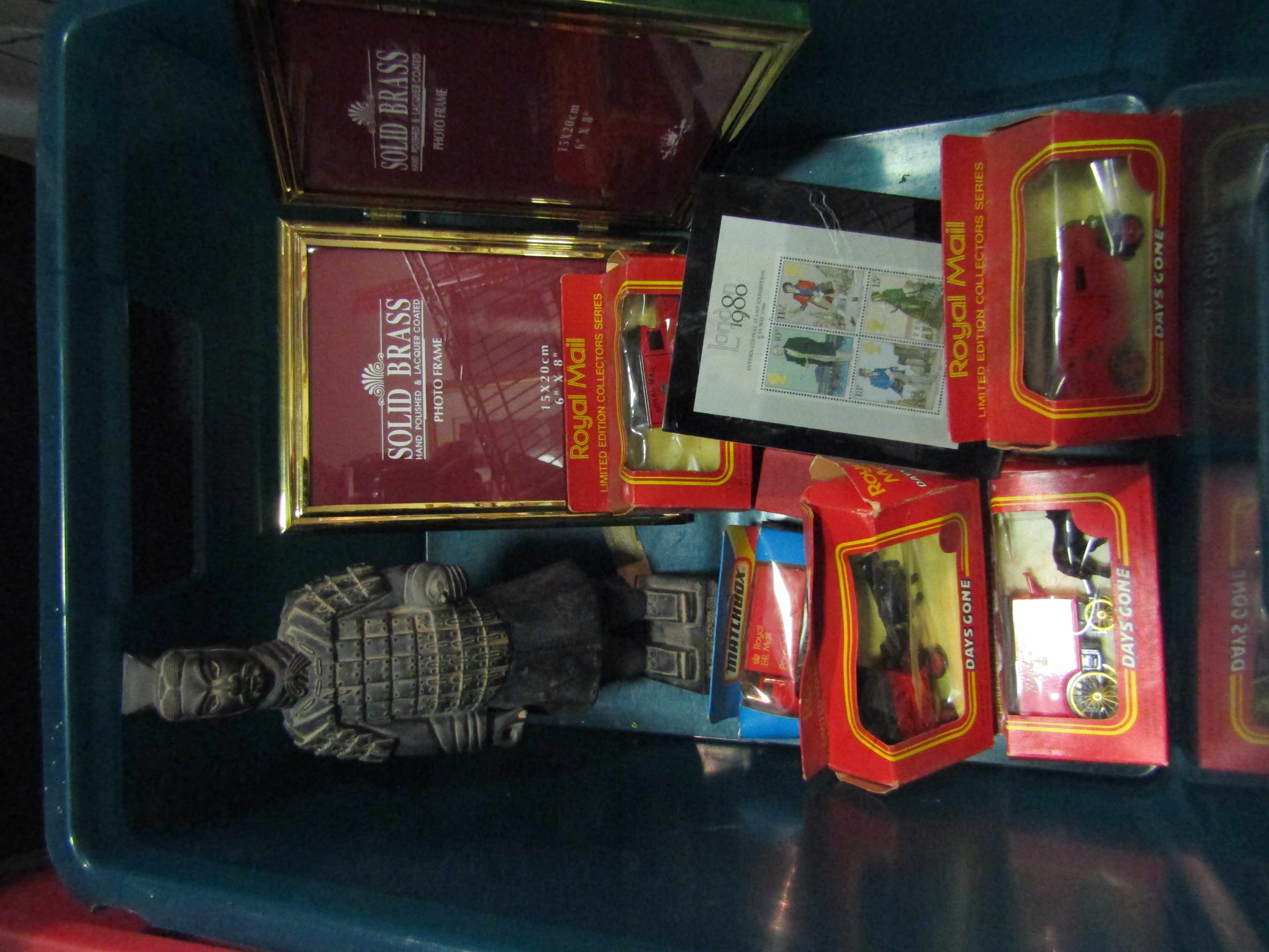 A box of toy cars and a small Chinese terracotta warrior