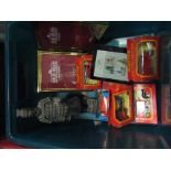 A box of toy cars and a small Chinese terracotta warrior