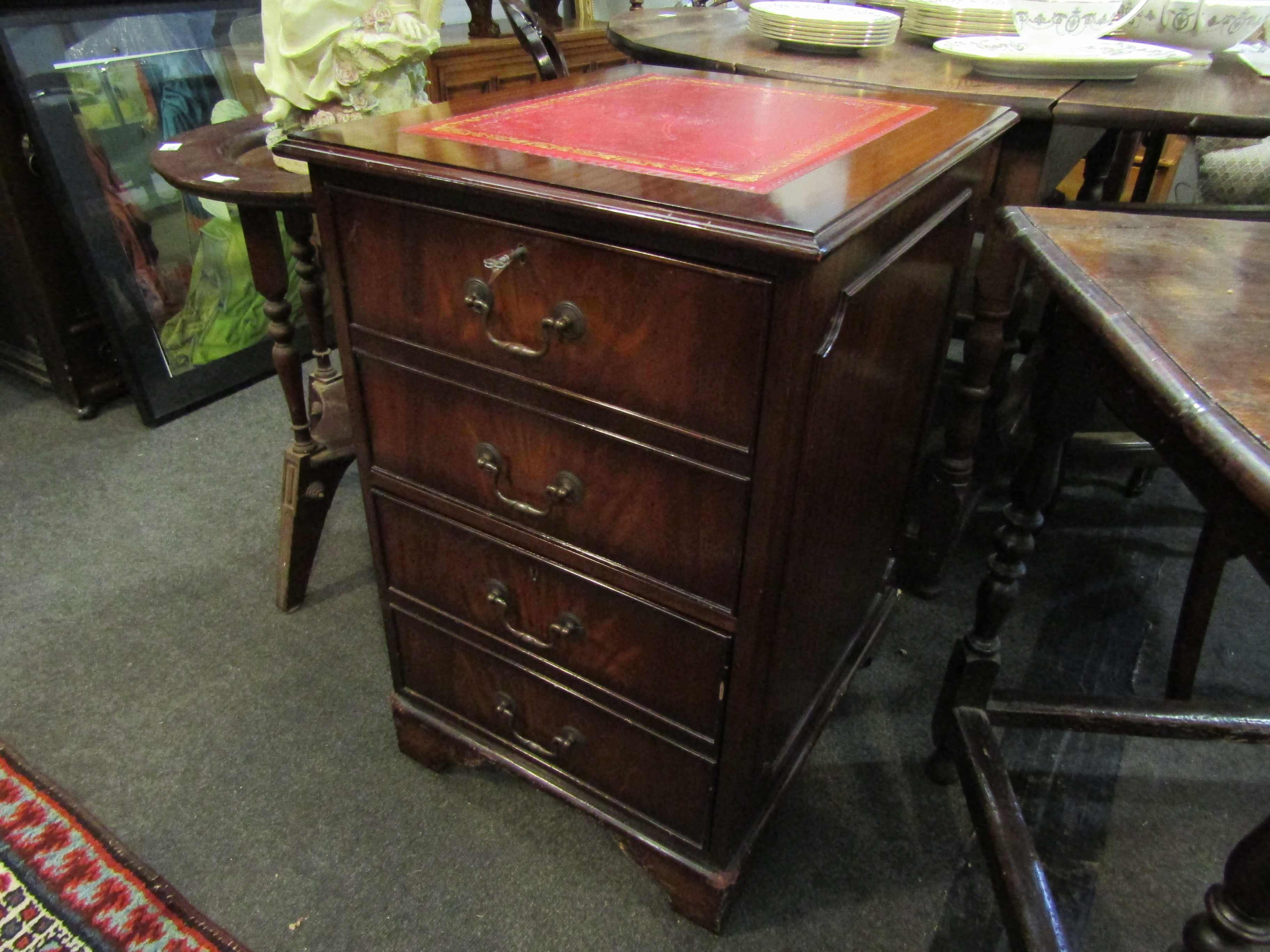 A Regency revival mahogany two drawer filing cabinet with tooled red leather top