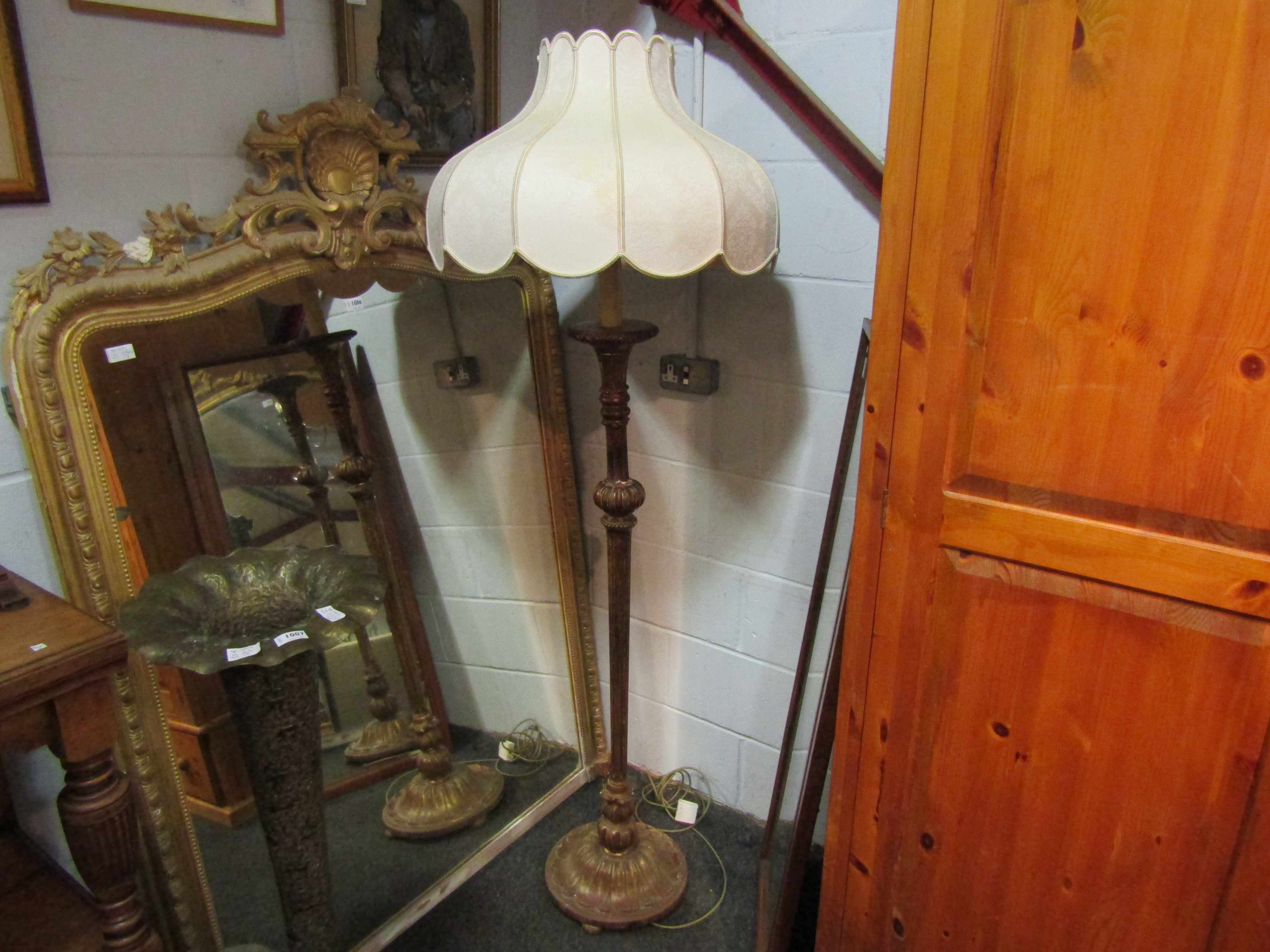 A gilded standard lamp with shade