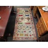 A multicoloured wool rug with animal field, 3' x 7' approx.