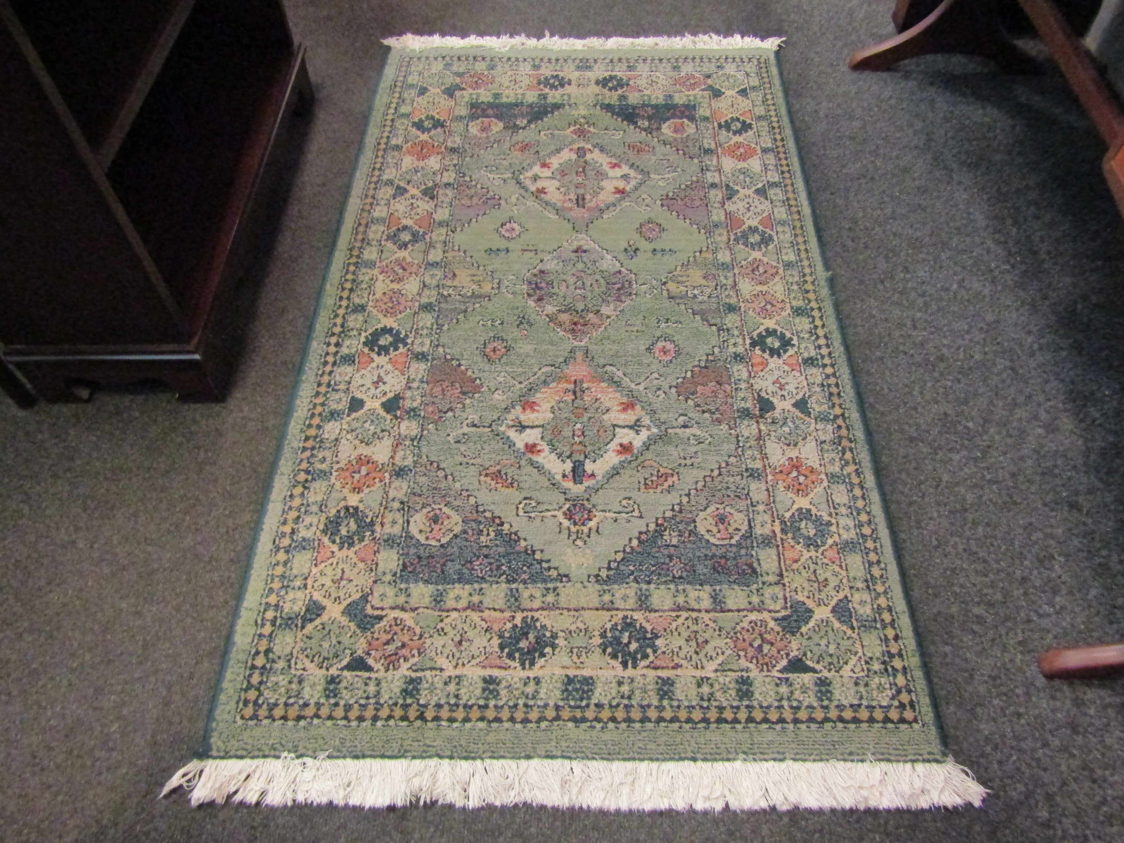 A Gabbeh green ground wool rug, central row of three guls and multiple borders, 3' x 4.5' approx.