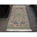 A Gabbeh green ground wool rug, central row of three guls and multiple borders, 3' x 4.5' approx.