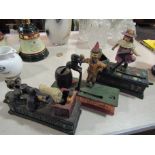 Three bygone cast metal money boxes including "Trick Dog",