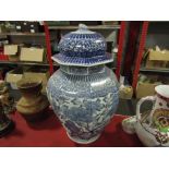 An oversized blue and white lidded floor vase,