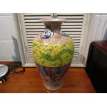 A Chinese porcelain baluster form vase with Imari palette foliate panels and green dragon on yellow