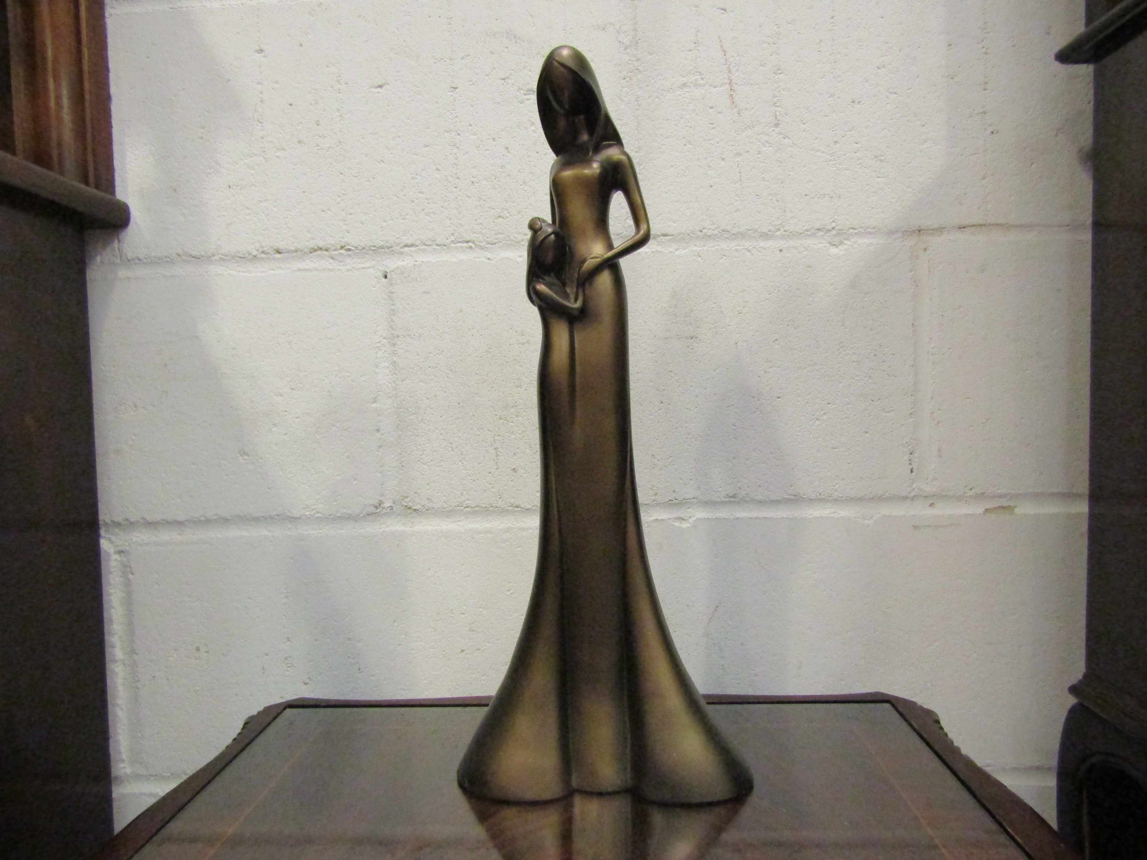 A resin bronze figure of mother and child,