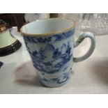 An Oriental blue and white tankard, staple repaired,