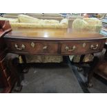 A Georgian mahogany bow fronted sideboard on cabriole legs with ball and claw feet,