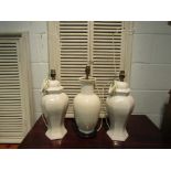 A pair of white ceramic lamp bases and another