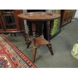 A late 19th Century oak pub table with spindle supports