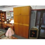 A mid Century Uniflex teak wardrobe, two pairs of doors,
