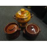 A slipware lidded twin handled pot with verse and two other lidded storage containers (3)