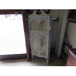 An Edwardian mahogany corner cabinet with hand painted glass doors with flowers and bees