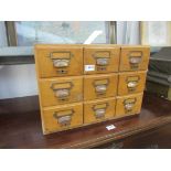 An oak nine drawer haberdashery unit "Coats Satinised" 91w x 40d x 36h cm