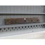 Five coat hooks on timber rail