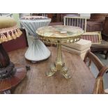 A circular marble top lamp table on a brass base