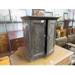 A vintage stained pine two door workshop cabinet stained