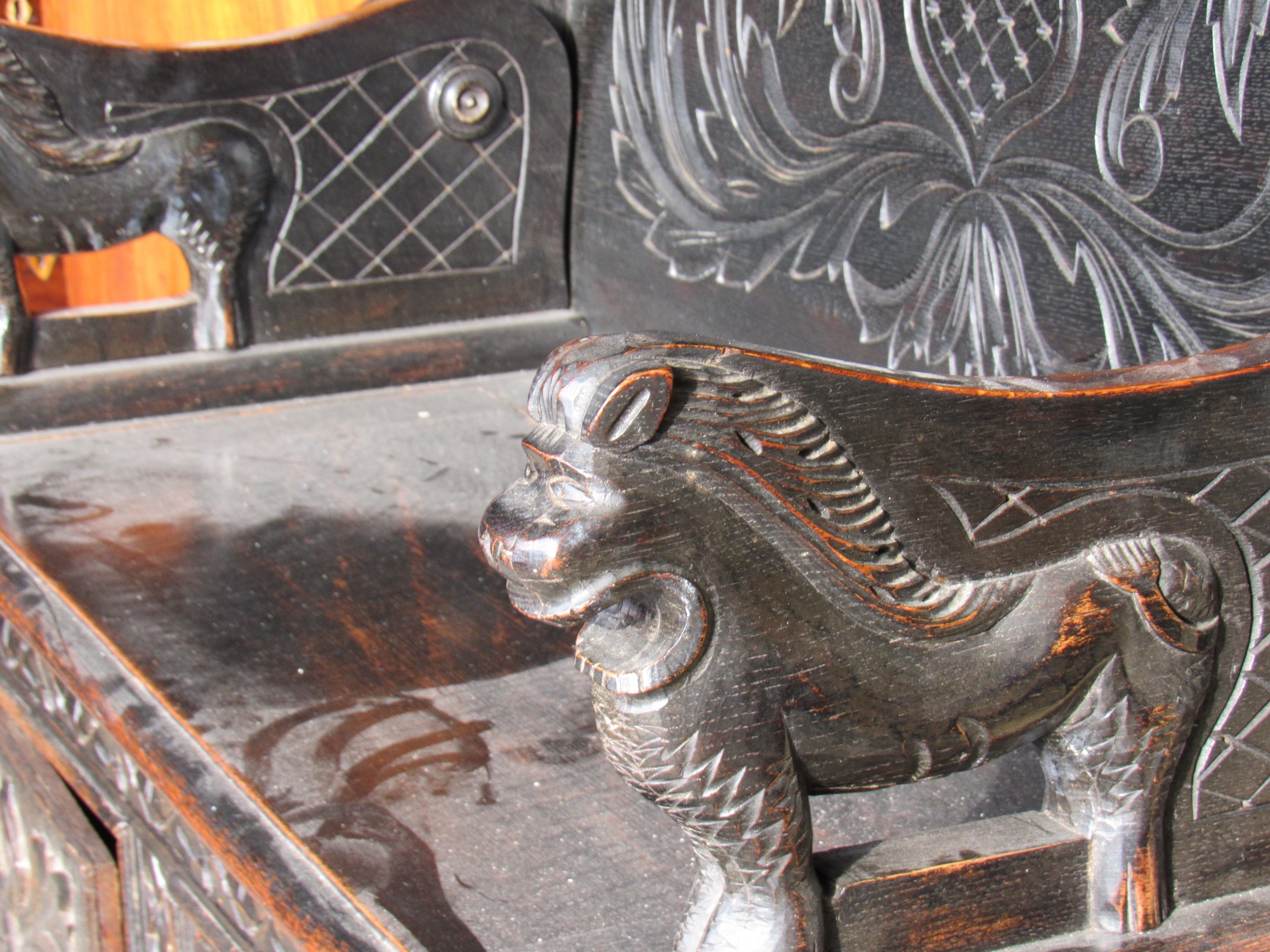 An Edwardian carved oak monks bench, with lift up seat, - Image 2 of 2