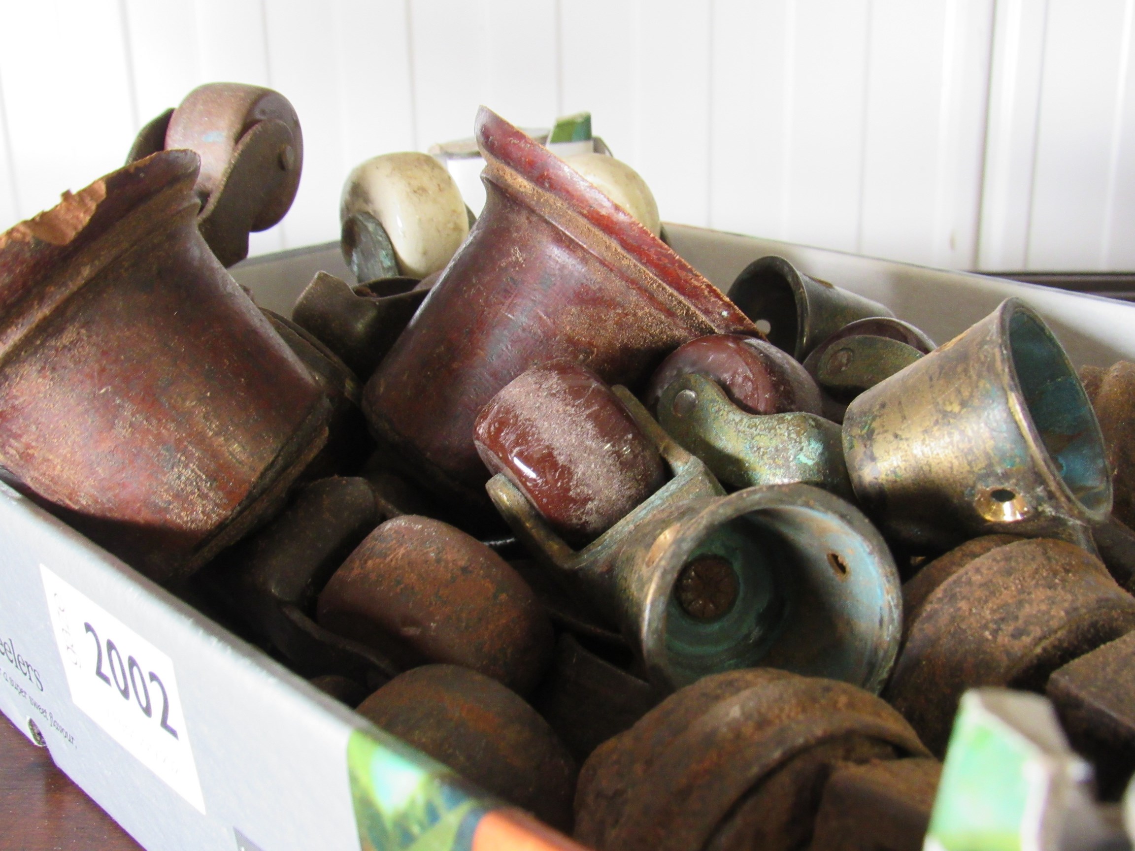 A set of four Victorian brass and brown porcelain castors and a box of odd castors - Image 2 of 2