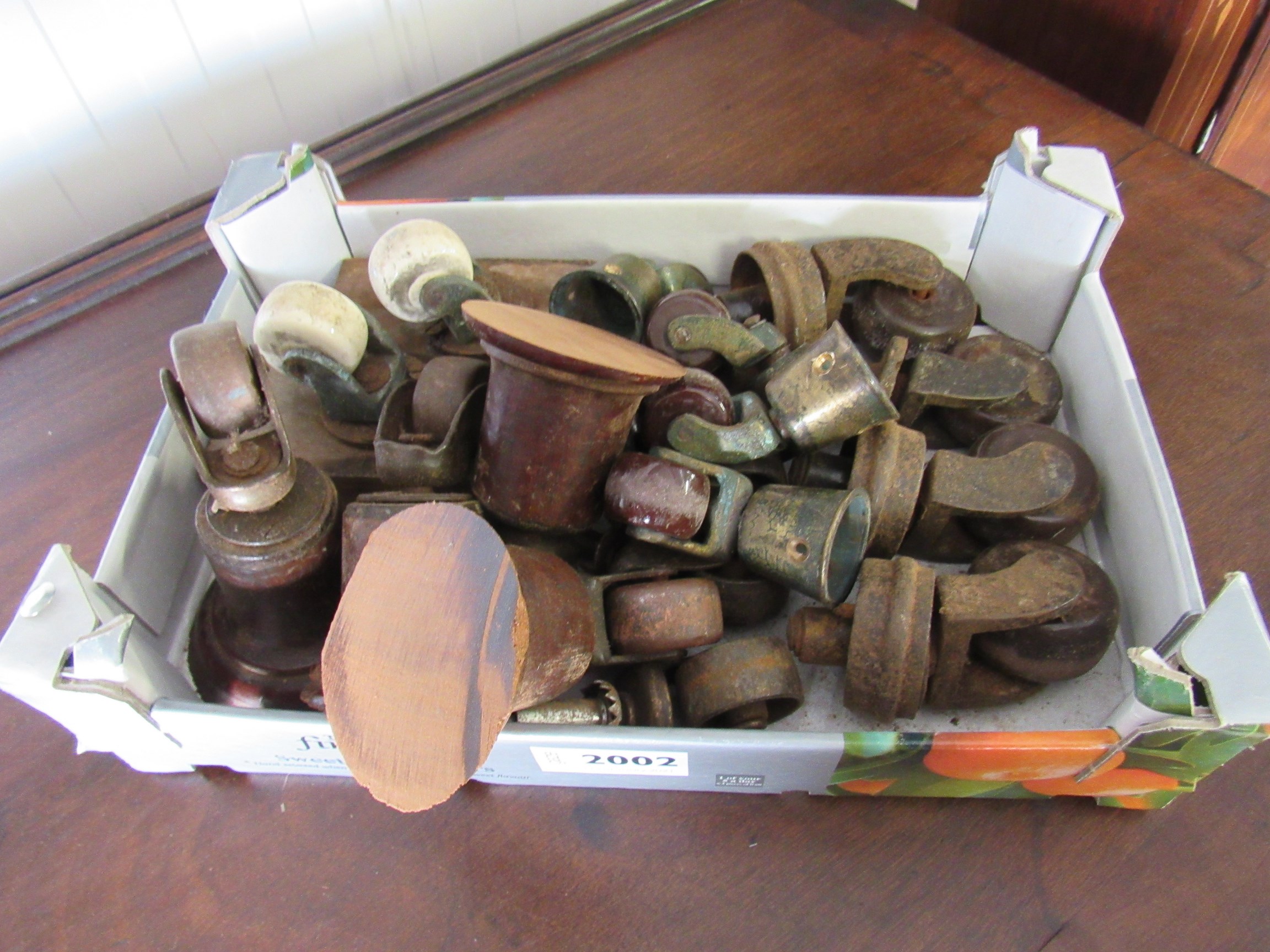 A set of four Victorian brass and brown porcelain castors and a box of odd castors