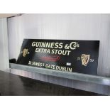 A Guinness advertising sign metal panel