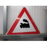 A painted triangular train road sign