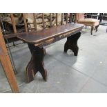 A Victorian waxed pine bench with trestle ends,